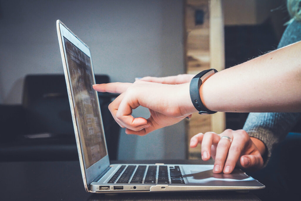 pointing to a laptop screen