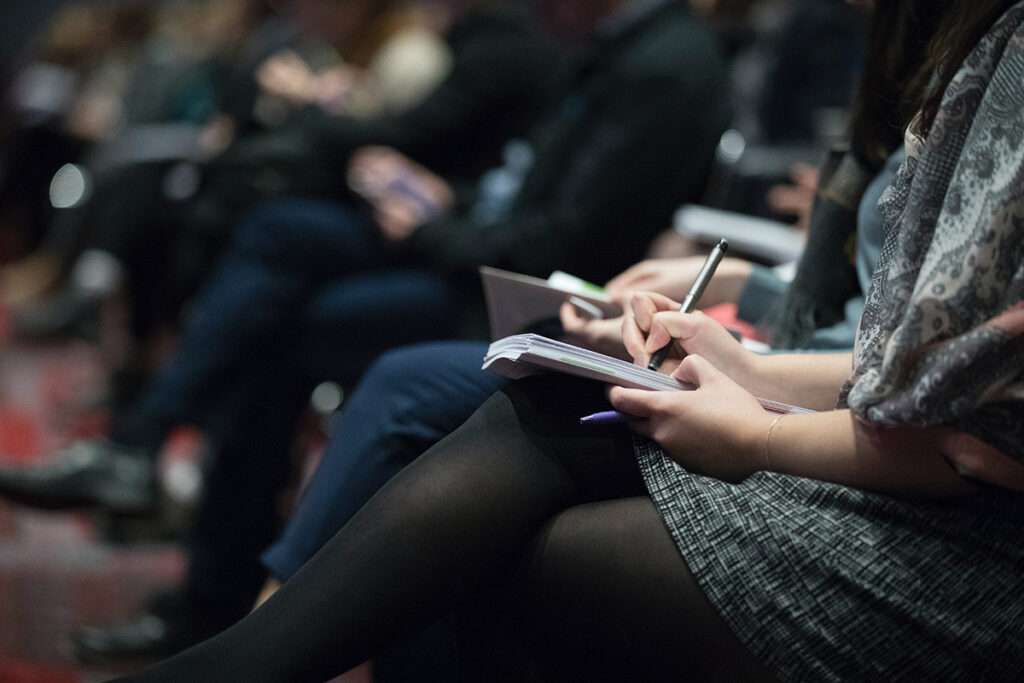 people sitting and taking notes