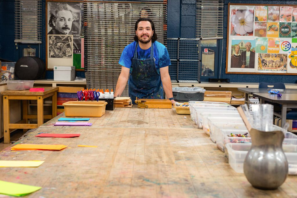 teacher with art supply table