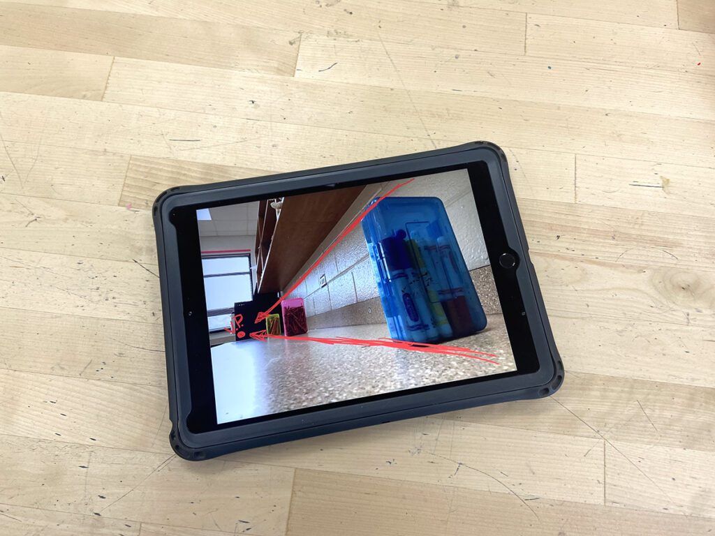 tablet with annotated lines on photo