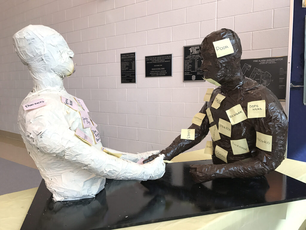 two casts of figures shaking hands