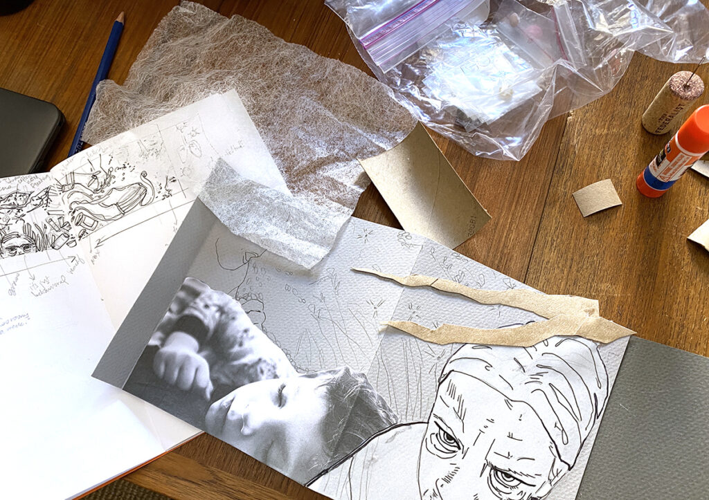 open sketchbook, work in progress, scattered supplies