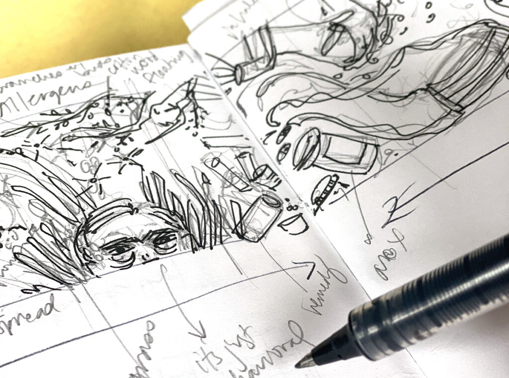 open sketchbook and ink pen