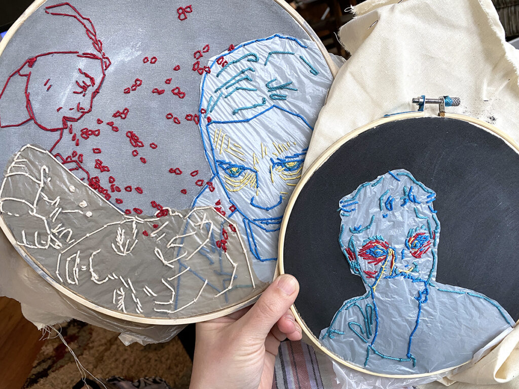 hand holding two embroidery hoops