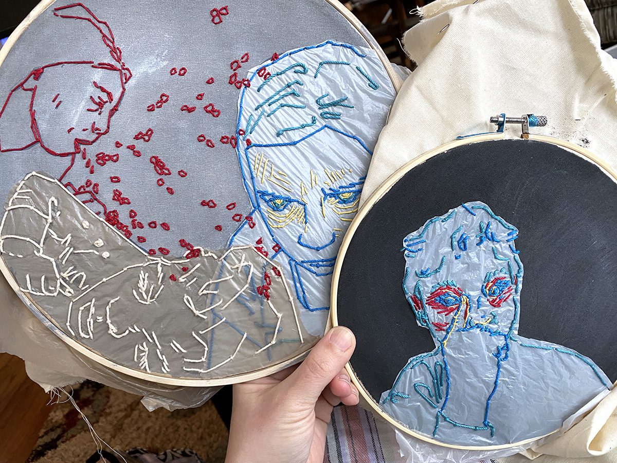hand holding two embroidery hoops