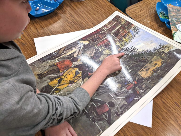 student pointing at painting