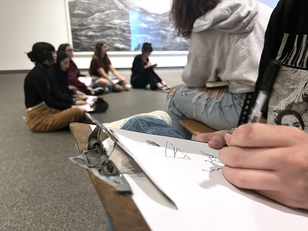 sitting in a circle with sketchbooks