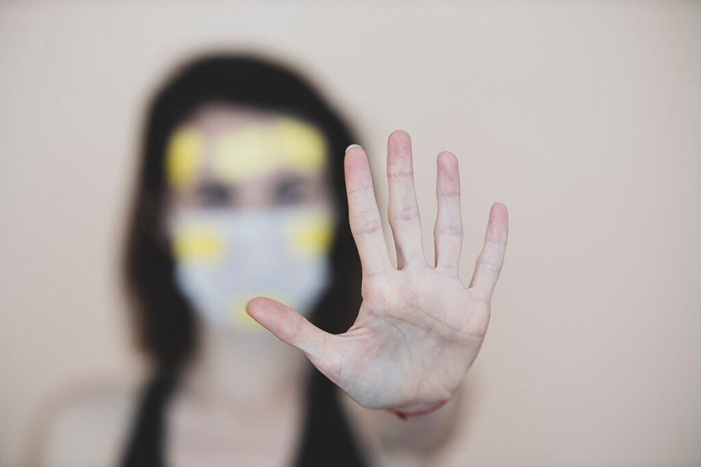 woman holding hand up to stop