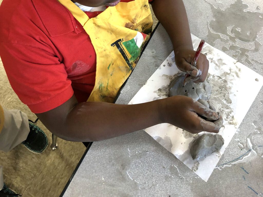 student working with clay
