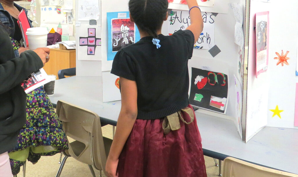 student showing art