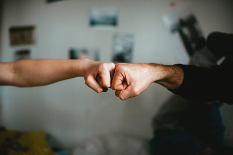 hands fist bumping