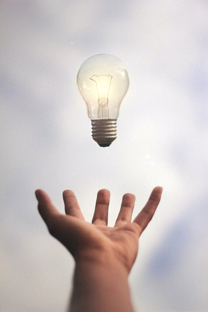 hand reaching for lightbulb
