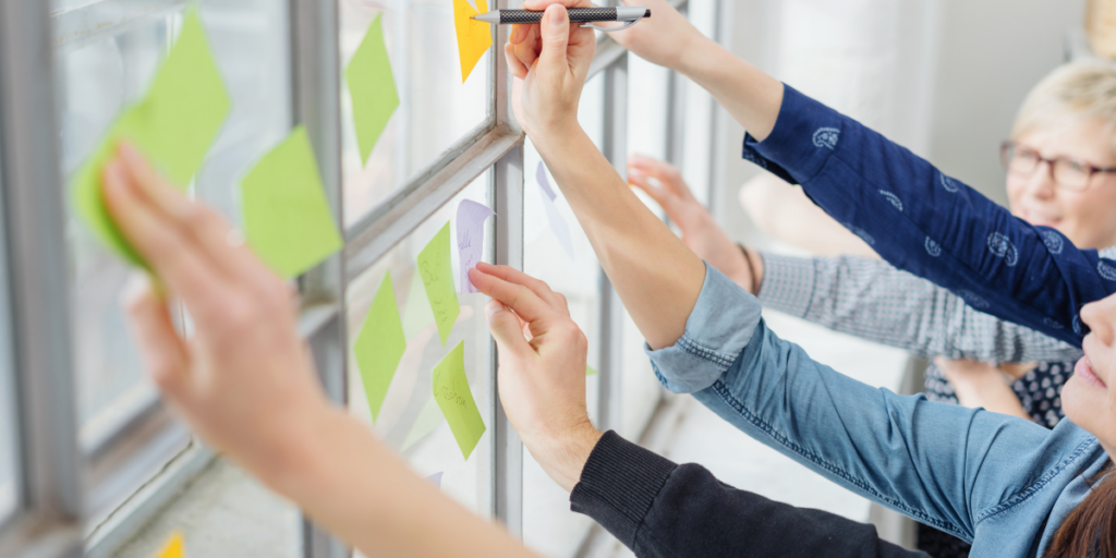hands with sticky notes